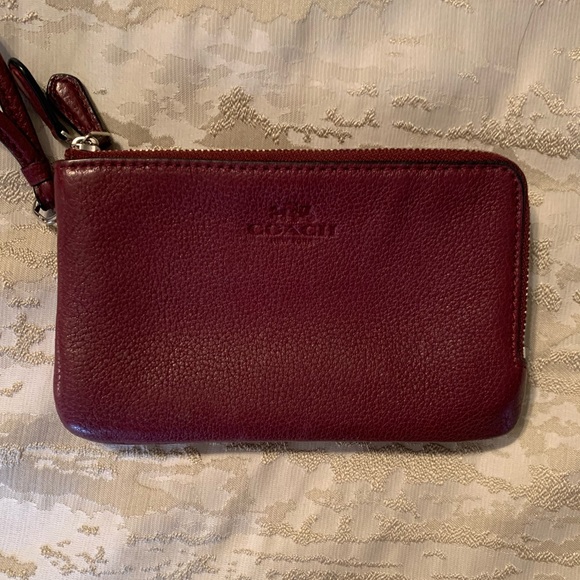 Coach Wristlet in a maroon color with 2 zippers